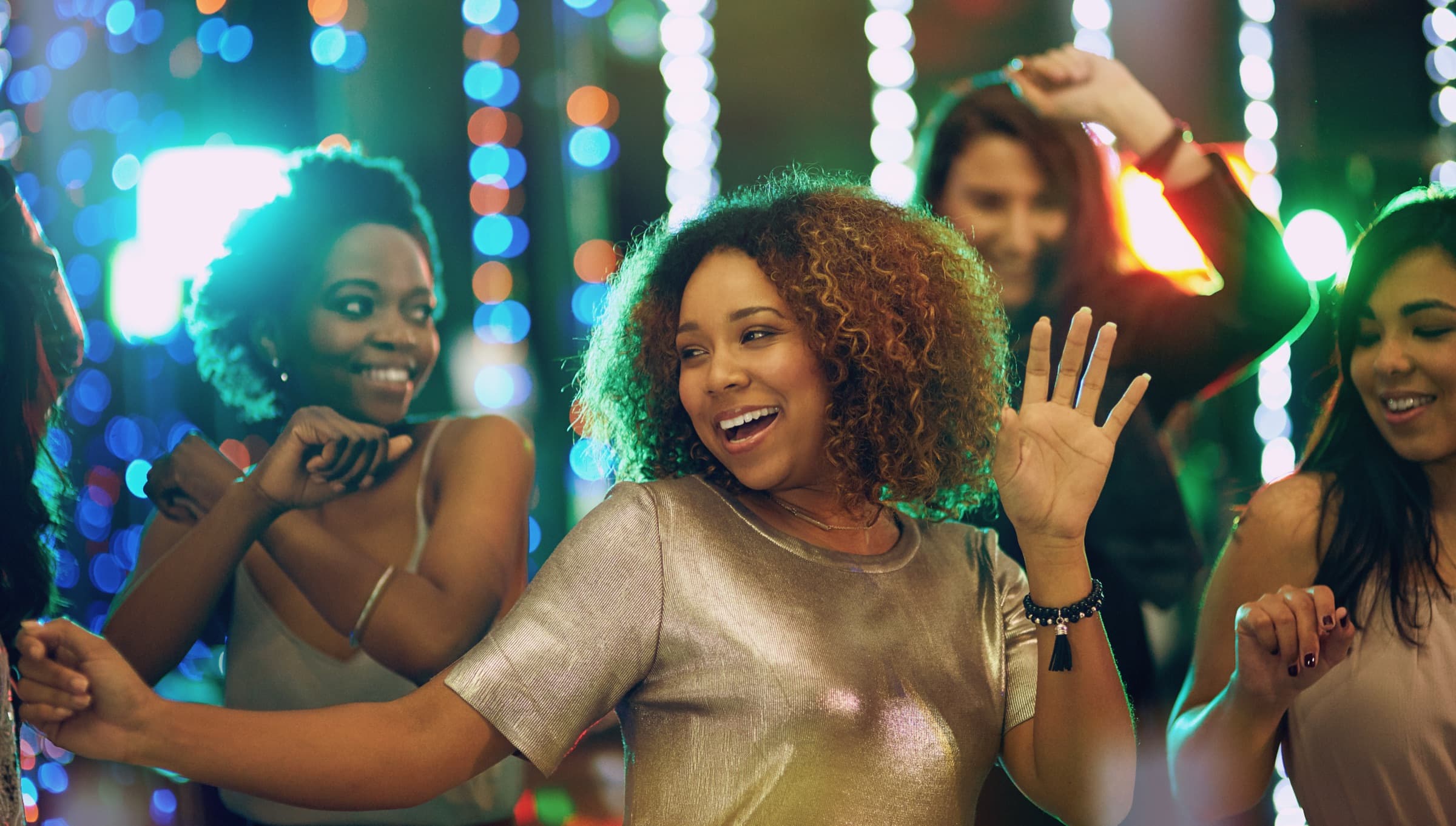 Friends dancing under the lights at a concert